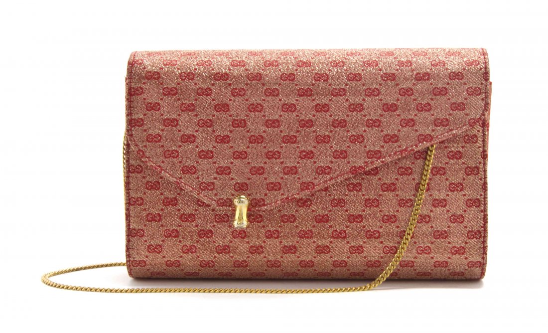 A Gucci Monogram Red and Gold Jacquard Bag, 8 1/4 x 4: A Gucci Monogram Red and Gold Jacquard Bag, hidden goldtone chain strap with goldtone closure. Stamped: Gucci. 8 1/4 x 4 1/2 x 1 1/2 inches. Property from the Estate of Betsy Pickering Kaiser