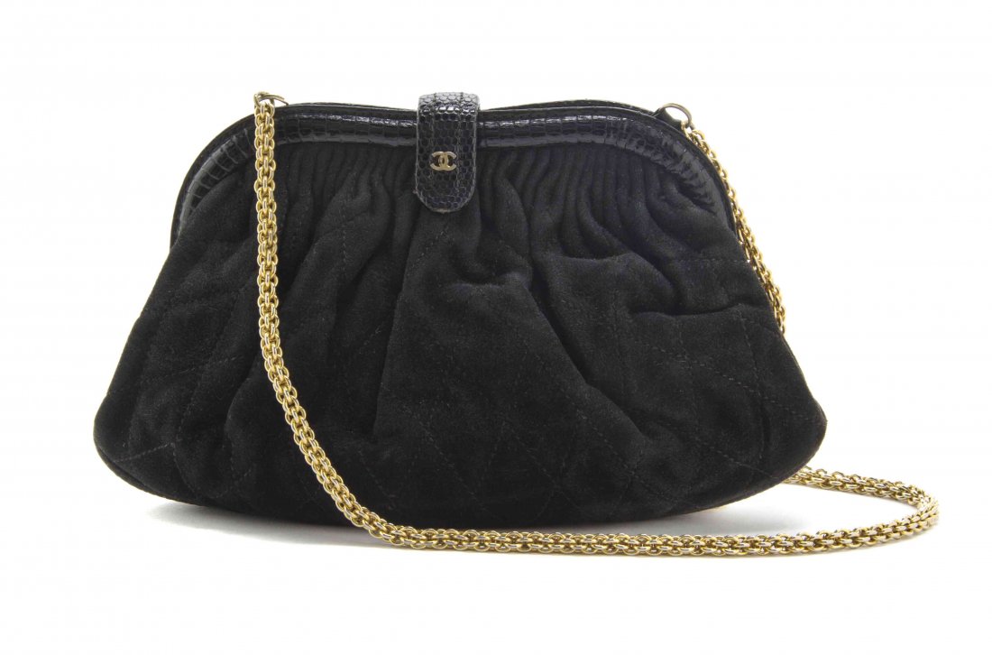 A Chanel Black Quilted Suede Bag, 8 x 5 x 2 inches.: A Chanel Black Quilted Suede Bag, hidden goldtone chain strap, with lizardskin trim and interlocking 'C' logo to the clasp. Stamped: Chanel. 8 x 5 x 2 inches. Property from the Estate of Betsy Pickeri