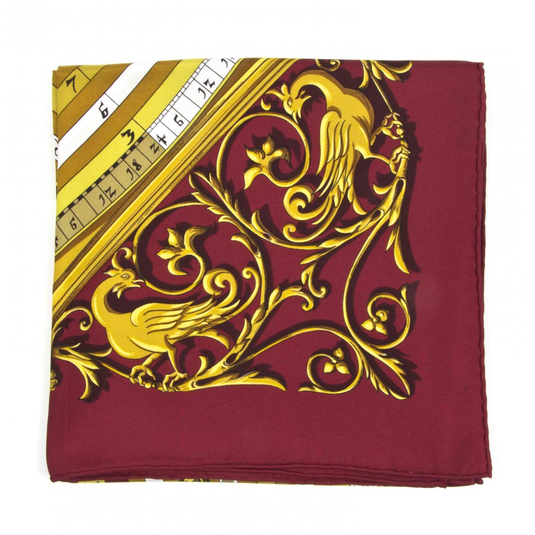 An Hermès Silk Scarf, 35 x 35 inches.: An Hermès Silk Scarf, in a 'Dies et Hore' motif. Labeled within print: Hermès. 35 x 35 inches. Property from the Estate of Betsy Pickering Kaiser