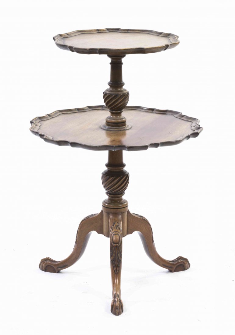 A Chippendale Style Two-Tier Table, Height 32 x: A Chippendale Style Two-Tier Table, each tier having a scalloped edge over the baluster form standard, raised on a tripartite base ending in claw and ball feet. Height 32 x diameter 22 inches.