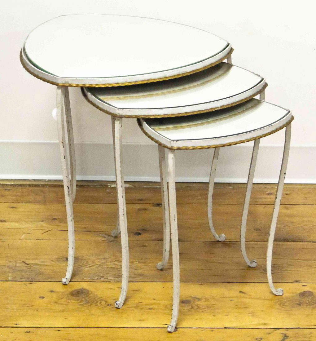 A Set of Three Painted Iron Nesting Tables, Height of: A Set of Three Painted Iron Nesting Tables, of shaped triangular form, having twist gilt decoration raised on three legs. Height of tallest 18 3/4 inches.