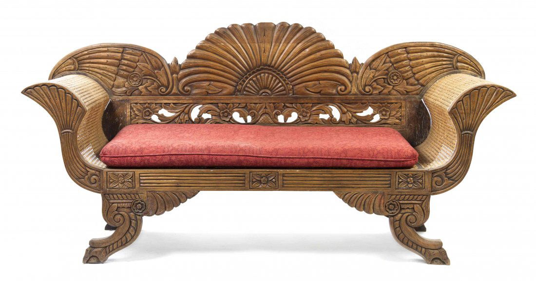 A Victorian Carved Oak Settee, Height 38 x width 78 x: A Victorian Carved Oak Settee, the back with scrolling and foliate decoration over the caned arms and seat raised on downward swept legs ending in claw and ball feet. Height 38 x width 78 x depth 24 i