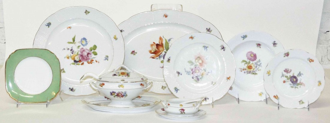 A German Porcelain Partial Dinner Service, Diameter of: A German Porcelain Partial Dinner Service, comprising 18 dinner plates, 6 luncheon plates, two sauces with spoons and underplate, a charger and an oval serving tray each with floral decoration on an i