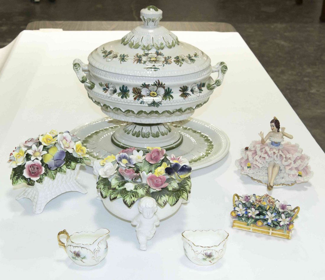 A Stoneware Soup Tureen and Undertray, Height of first: A Stoneware Soup Tureen and Undertray, having floral polychrome decoration on a white ground, together with three porcelain floral arrangements, one marked capodimonte, a porcelain figurine and a crea