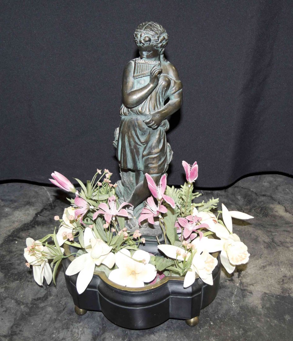 A Bronzed Plaster Figural Planter, Height 18 1/4: A Bronzed Plaster Figural Planter, depicting a lady with a flute. Height 18 1/4 inches.