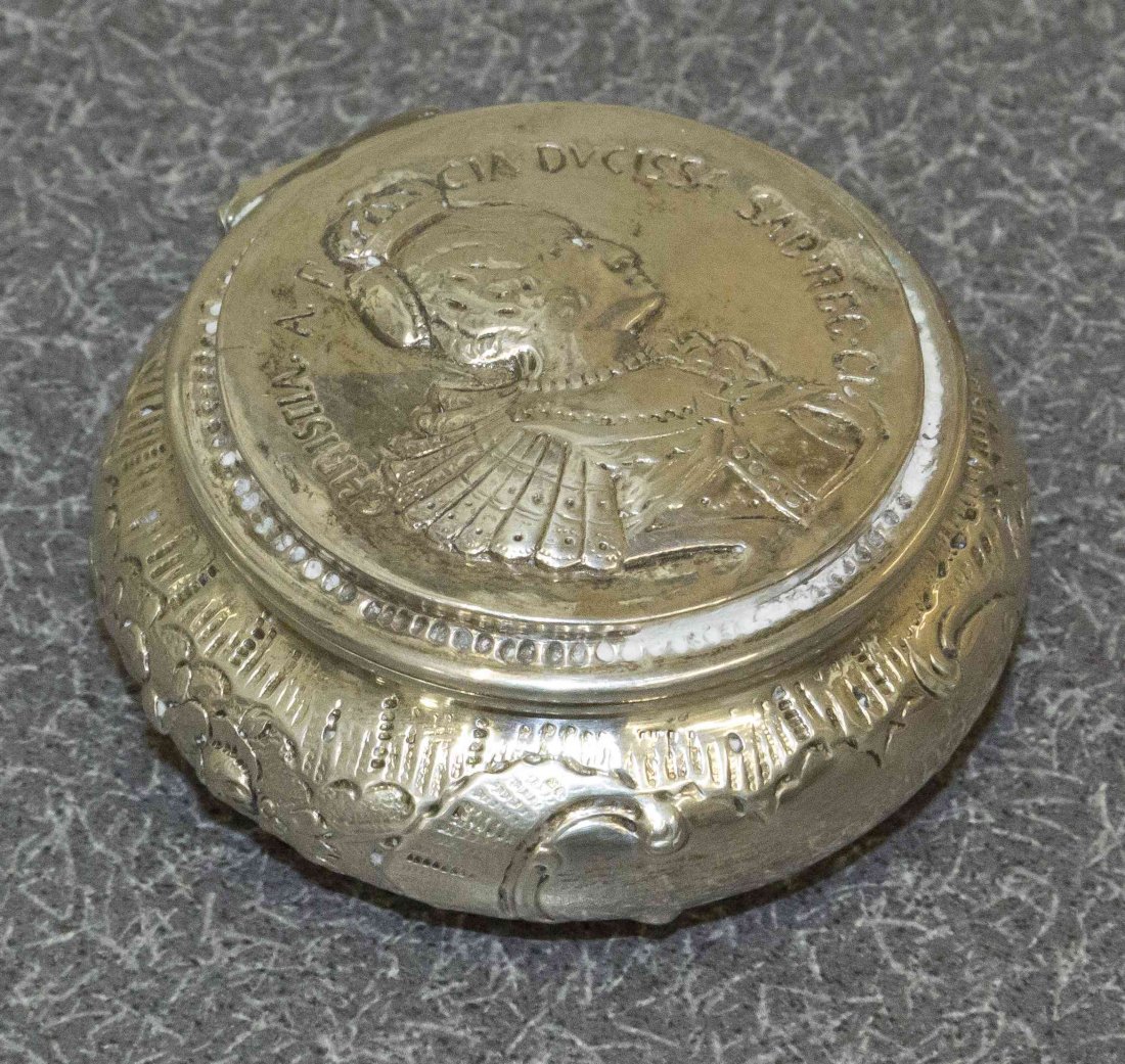 A German Silver Snuff Box, Probably Hanau, Late 19th: A German Silver Snuff Box, Probably Hanau, Late 19th Century, circular, the sides embossed with flowers and raocaille, the cover with the profile of Christine of France, Duchess of Savoy, after a meda