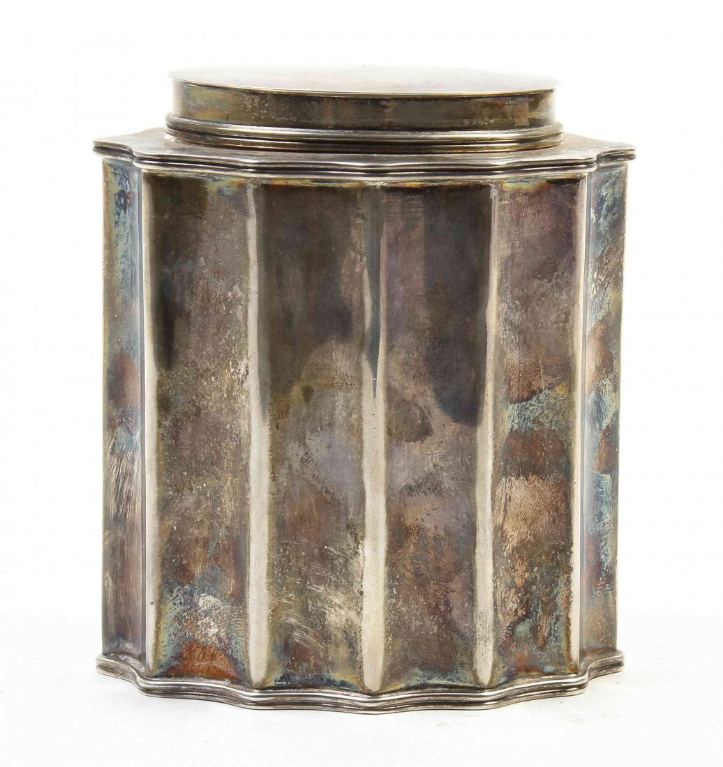 An American Silver Tea Caddy, James Woolley, Boston,: An American Silver Tea Caddy, James Woolley, Boston, Massachusetts, having a plain oval lid and oval in form with pinched sides, the base marked Woolley; 6.66 ozt. Height 4 inches.