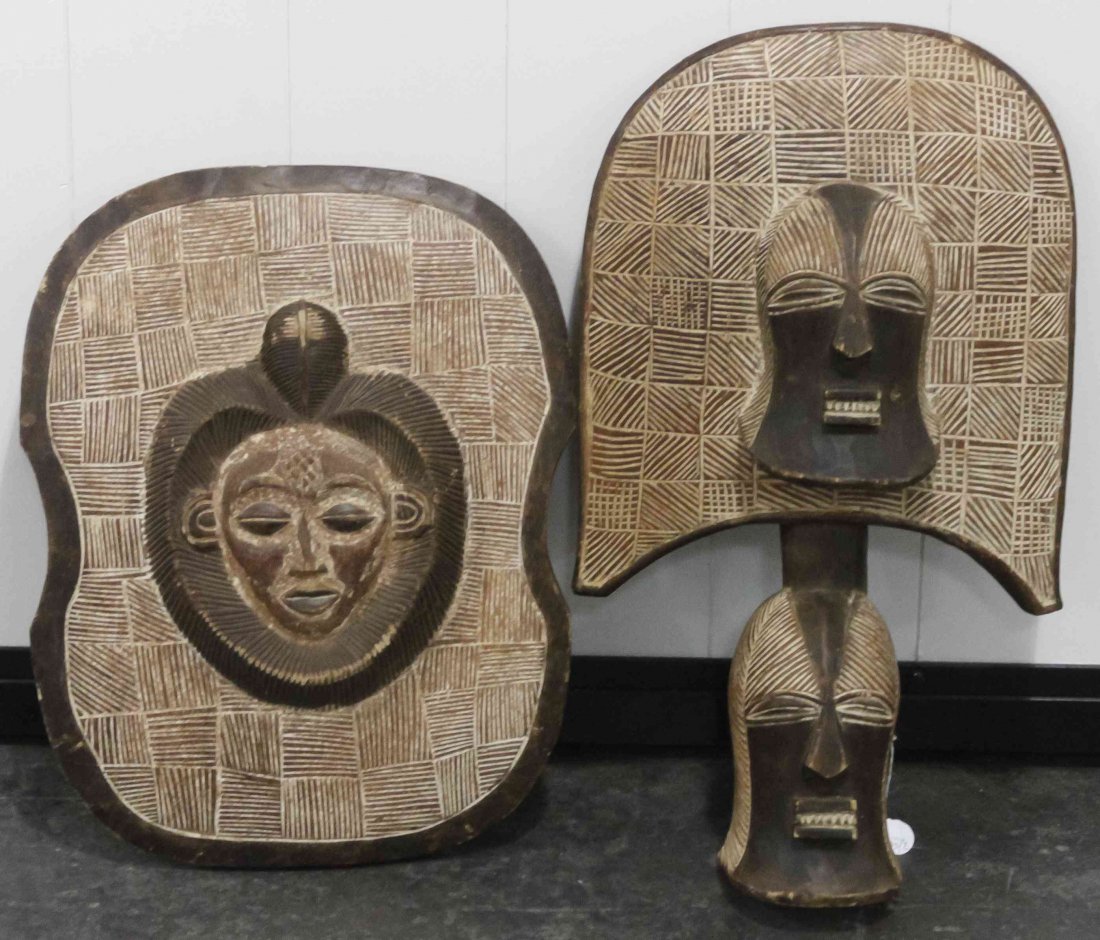 Two Baluba Carved Wood Articles, Heihgt of tallest 24: Two Baluba Carved Wood Articles, comprising a mask and a shield, each with incised linear decoration. Heihgt of tallest 24 1/4 inches. Property from the Collection of Gerald F. Glaeve, Mount Horeb, Wi