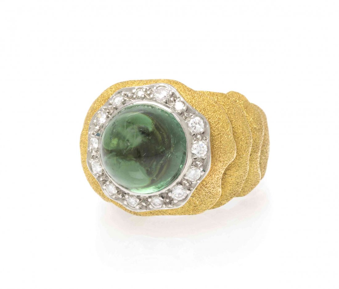 An 18 Karat Yellow Gold, Tourmaline and Diamond Ring,: An 18 Karat Yellow Gold, Tourmaline and Diamond Ring, Grima, containing one round cabochon cut green tourmaline weighing approximately 8.75 carats and 14 round brilliant cut diamonds weighing approxim