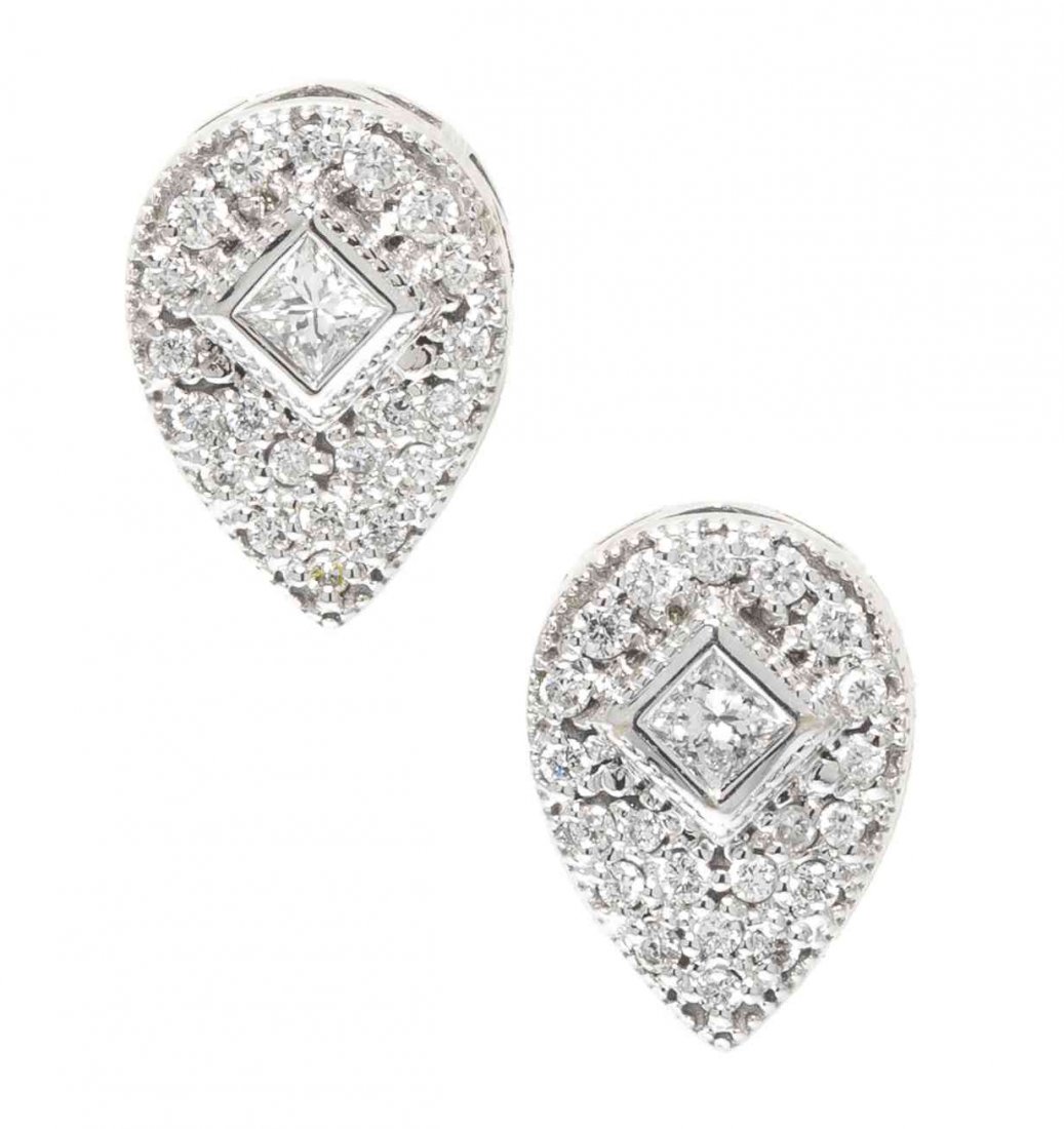 A Pair of 18 Karat White Gold and Diamond Flamme: A Pair of 18 Karat White Gold and Diamond Flamme Blanche Earrings, Charriol, containing two princess cut diamonds weighing approximately 0.14 carat total and numerous round brilliant cut diamonds weig