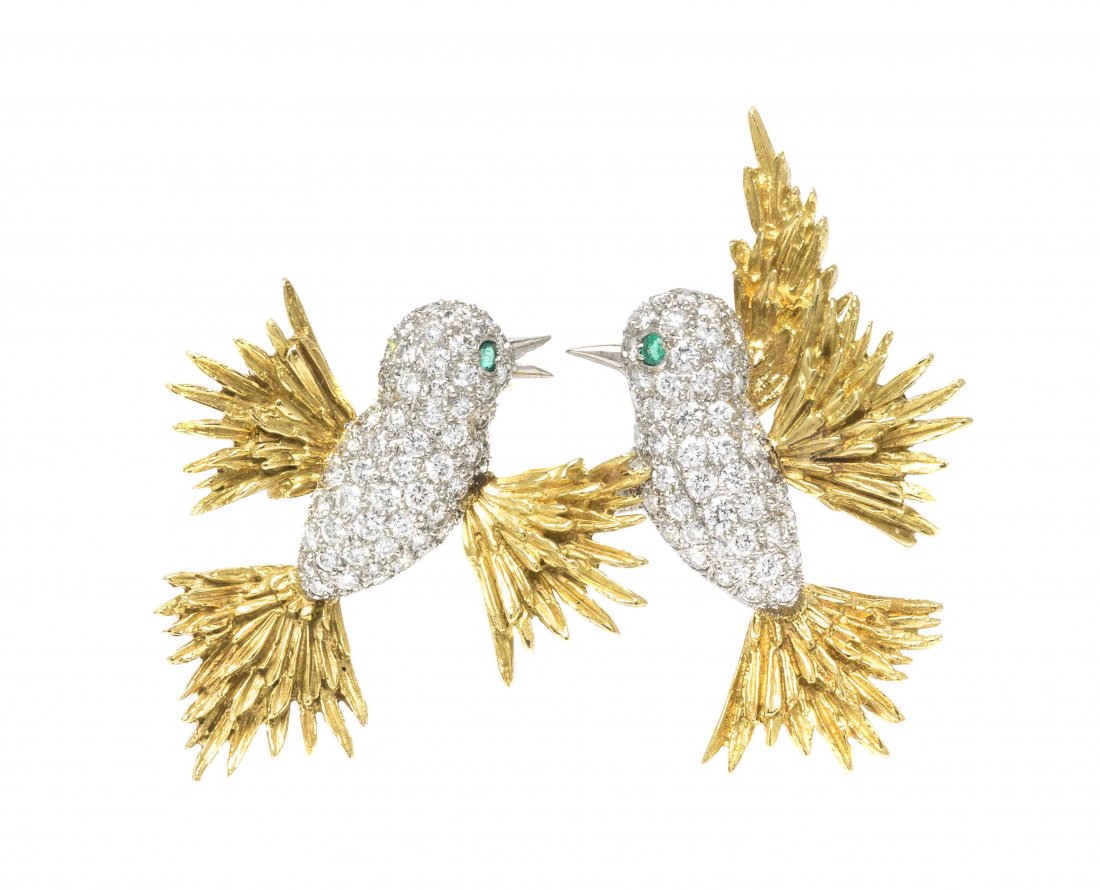 A Platinum, 18 Karat Yellow Gold, Diamond and Emerald: A Platinum, 18 Karat Yellow Gold, Diamond and Emerald Hummingbird Brooch, McTeigue, consisting of pave set platinum bodies with textured gold feathers, containing numerous round brilliant cut diamonds