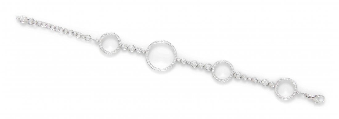 An 18 Karat White Gold and Diamond Bracelet, Antonini,: An 18 Karat White Gold and Diamond Bracelet, Antonini, consisting of four open circular links joined by round cluster and bezel set links and cable chain link, containing numerous round brilliant cut