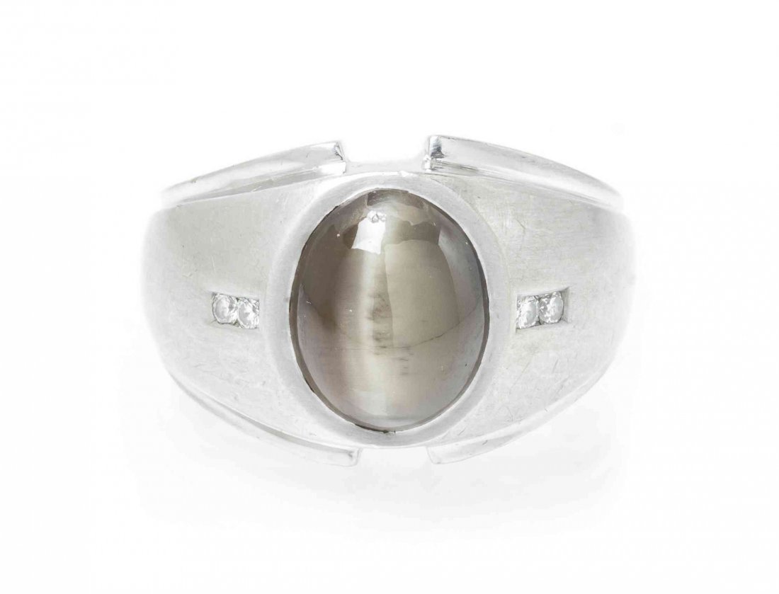 A 14 Karat White Gold, Cat's Eye Chrysoberyl and: A 14 Karat White Gold, Cat's Eye Chrysoberyl and Diamond Ring, containing one oval cabochon cut chrysoberyl measuring approximately 10.09 x 8.50 x 8.00 mm and four round brilliant cut diamonds weighin