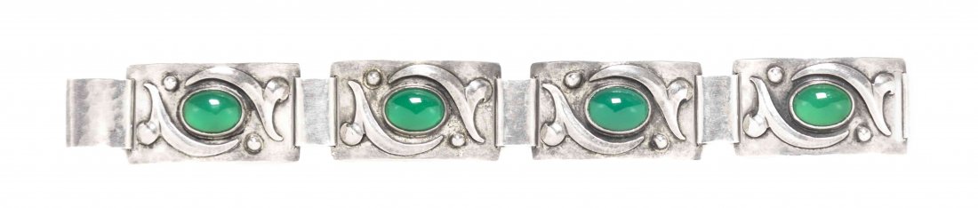 An Arts and Crafts Sterling Silver and Dyed Green: An Arts and Crafts Sterling Silver and Dyed Green Chalcedony Bracelet, Bjarne, consisting of four rectangular links with applied design, containing four oval cabochon cut dyed green chalcedony. Stamp: