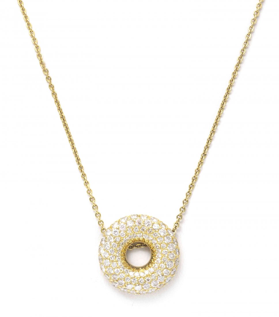 An 18 Karat Yellow Gold and Diamond Circle Pendant: An 18 Karat Yellow Gold and Diamond Circle Pendant Necklace, Jose Hess, consisting of a pierced circular pav? set pendant containing numerous round brilliant cut diamonds weighing approximately 1.34 c