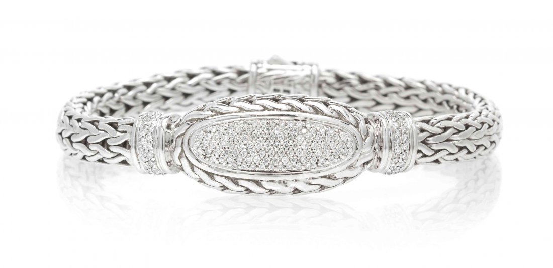 A Sterling Silver and Diamond Classic Chain Bracelet,: A Sterling Silver and Diamond Classic Chain Bracelet, John Hardy, in a woven link design with a central oval and fluted section pave set with 136 round brilliant cut diamonds weighing approximately 0.