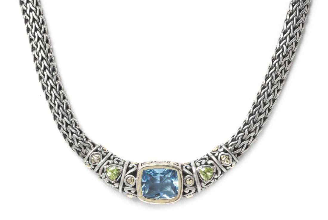 A Sterling Silver, 18 Karat Yellow Gold, Blue Topaz and: A Sterling Silver, 18 Karat Yellow Gold, Blue Topaz and Peridot Necklace, John Hardy, containing one modified cushion cut blue topaz weighing approximately 10.50 carats and two triangular brilliant cu