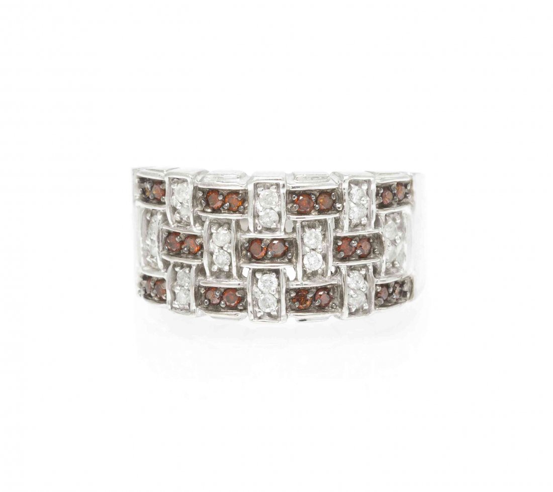 A 14 Karat White Gold, Diamond and Garnet Ring, 3.60: A 14 Karat White Gold, Diamond and Garnet Ring, in a basket weave motif, containing 20 round brilliant cut diamonds weighing approximately 0.20 carat total and numerous round brilliant cut orange red 
