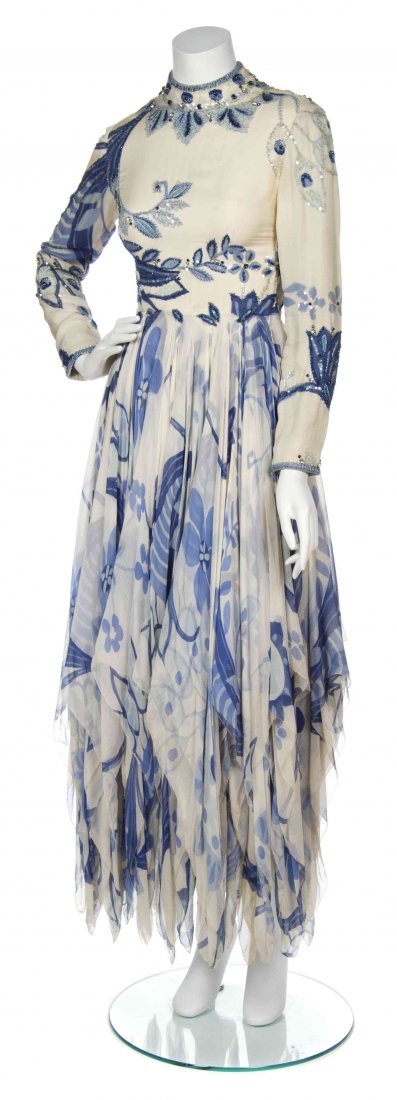 A George Halley Cream Silk and Chiffon Printed Dress,: A George Halley Cream Silk and Chiffon Printed Dress, long sleeves with an all-over blue floral print, bead, rhinestone and sequin embroidered silk bodice together with a cascading handkerchief hem ch