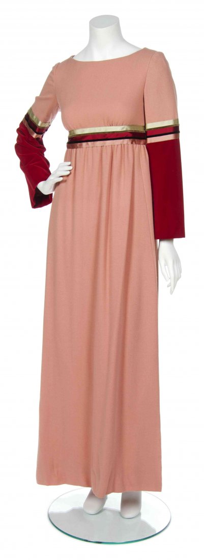 A George Halley Peach Crepe Gown,: A George Halley Peach Crepe Gown, with gold, ruby and peach ribbon trim to waist and ruby velvet panel to sleeves. Labeled: George Halley New York. Property from the Collection of George Halley, New Y