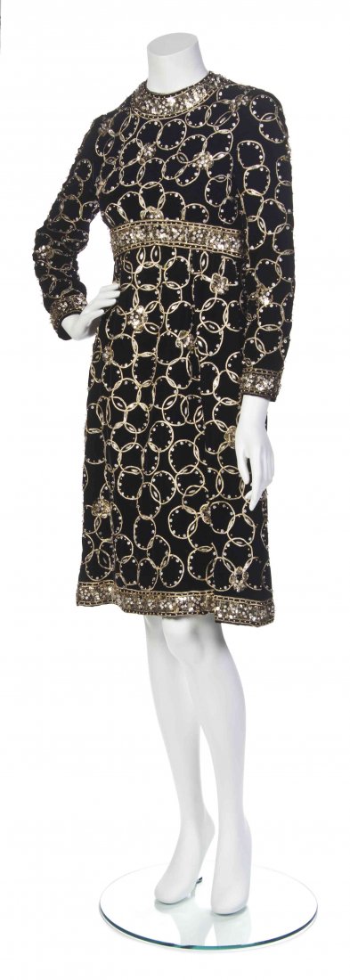 An Elinor Simmons for Malcolm Starr Black Velvet: An Elinor Simmons for Malcolm Starr Black Velvet Cocktail Dress, with empire waist, all-over interlocking circle metallic embroidery trim and sequin embellishment. Labeled: Elinor Simmons for Malcom S