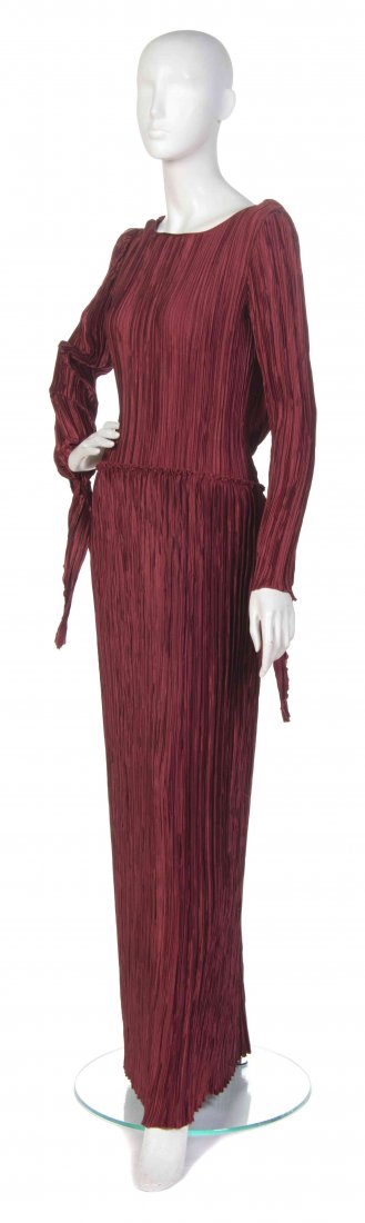 A Mary McFadden Bordeaux Marii Pleated Dress,: A Mary McFadden Bordeaux Marii Pleated Dress, (American, b. 1938) long sleeves with wide neckline and cowl draped back. red pleated no size. Property from the Ebony Fashion Fair Collection, Chicago, I