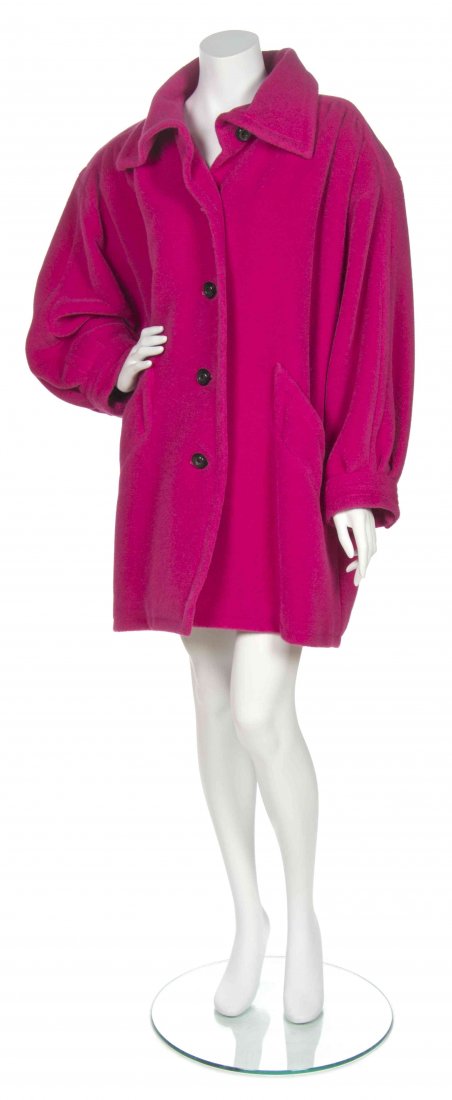 An Yves Saint Laurent Fuchsia Coat,: An Yves Saint Laurent Fuchsia Coat, circa 1980, button down front with two front pockets and a yoke to the front and back shoulders. Labeled: Saint Laurent Rive Gauche.