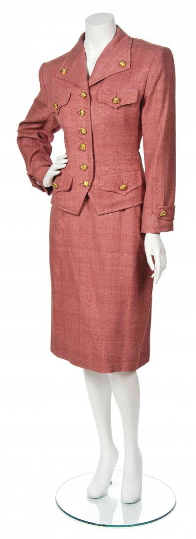 An Yves Saint Laurent Pink Silk Skirt Suit,: An Yves Saint Laurent Pink Silk Skirt Suit, circa 1980, comprised of a single breasted jacket with goldtone buttons and four patch pockets to the front, together with a fitted skirt. Labeled: Saint La