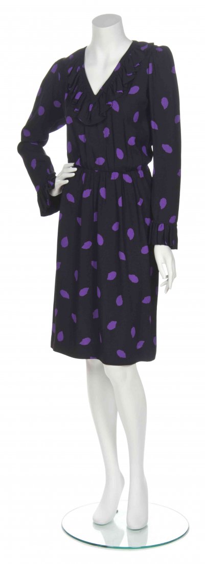 An Yves Saint Laurent Black and Purple Print Crepe: An Yves Saint Laurent Black and Purple Print Crepe Dress, ruffle V-neck with long sleeves and ruffle to cuffs. Labeled: Saint Laurent Rive Gauche.