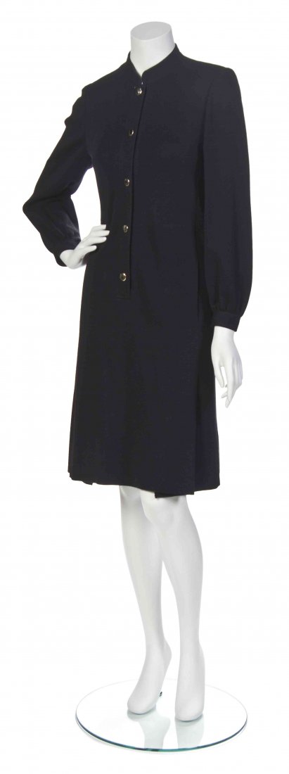 A Givenchy Black Wool Jersey Shirtwaist Dress,: A Givenchy Black Wool Jersey Shirtwaist Dress, circa 1985, button front with two pleat bottom. Labeled: Boutique Givenchy / 29295.