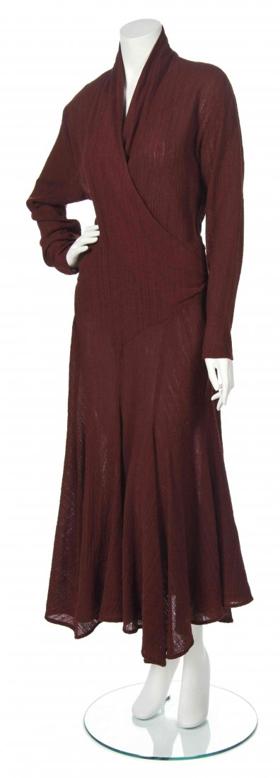 A Norma Kamali Maroon Evening Dress, Size 12.: A Norma Kamali Maroon Evening Dress, circa 1970, long sleeves with a surplice neckline and flared skirt. Labeled: Norma Kamali. Size 12.