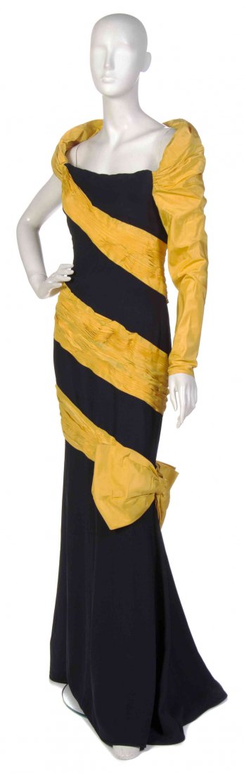 A Valentino Yellow and Black Gown,: A Valentino Yellow and Black Gown, (Italian, b. 1932) single long sleeve with yelllow contrast panels and a yellow bow to side of the skirt. Labeled: Valentino. yellow and black pleated silk size 10. 