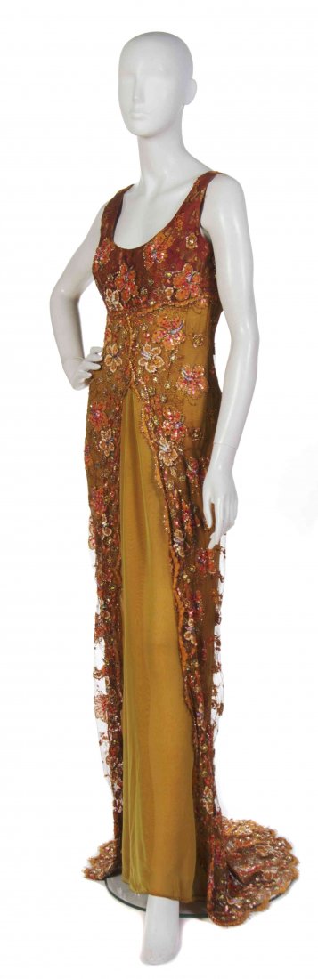 A Bill Blass Orange Lace and Chiffon Evening Gown,: A Bill Blass Orange Lace and Chiffon Evening Gown, (American, 1922-2002) sleeveless with a train hem and all-over sequin embroidery to the lace. Labeled: Bill Blass. orange chiffon with net overlay an