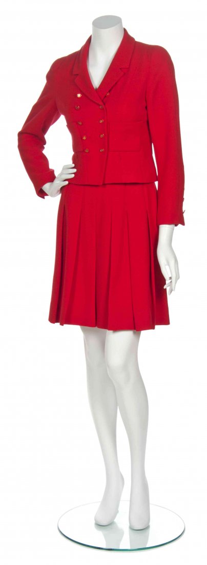 A Chanel Red Wool Skirt Suit, Size 36.: A Chanel Red Wool Skirt Suit, Spring 1995, comprised of a cropped double breasted jacket with interlocking 'C' logo buttons and two patch pockets together with a knife pleated skirt. Labeled: Chanel B