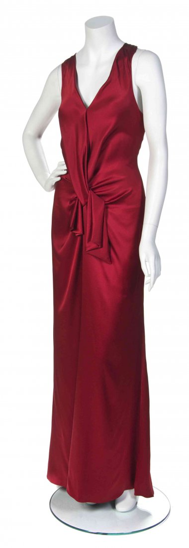 A Givenchy Red Silk Evening Gown,: A Givenchy Red Silk Evening Gown, with halter neckline, knot waist detail and matching fringe scarf. Labeled: Givenchy.