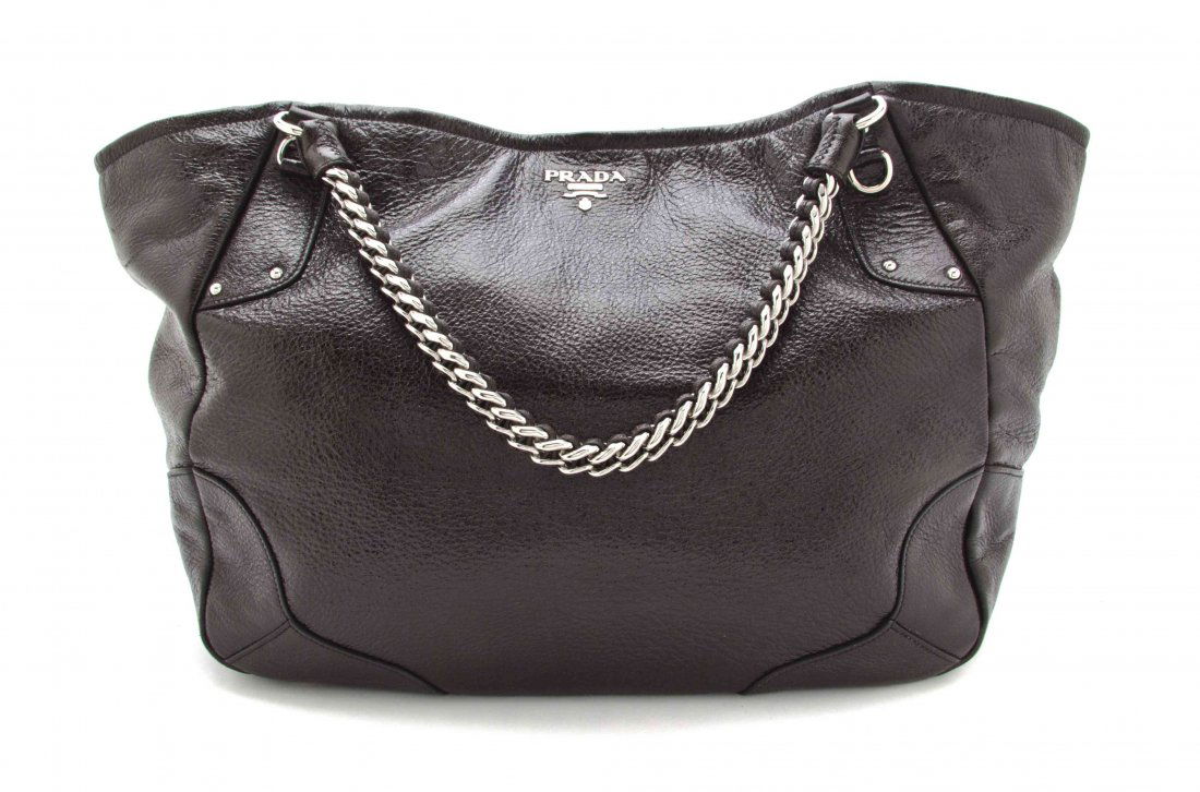 A Prada Brown Faux Leather Tote Bag, 18 3/4 x 13 1/4 x: A Prada Brown Faux Leather Tote Bag, metallic sheen to leather, with two silvertone chain link straps, and an interior zippered pocket. Stamped: Prada. 18 3/4 x 13 1/4 x 16 1/2 inches. Property from t