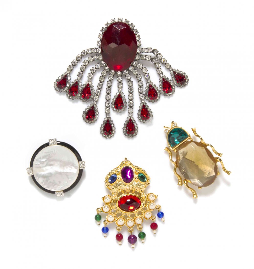 A Group of Four Kenneth Jay Lane Brooches,: A Group of Four Kenneth Jay Lane Brooches, comprised of a multicolor rhinestone and faux pearl Mughal style brooch stamped KJL, a mother of pearl and black enamel disk stamped Kenneth Lane, a yellow a