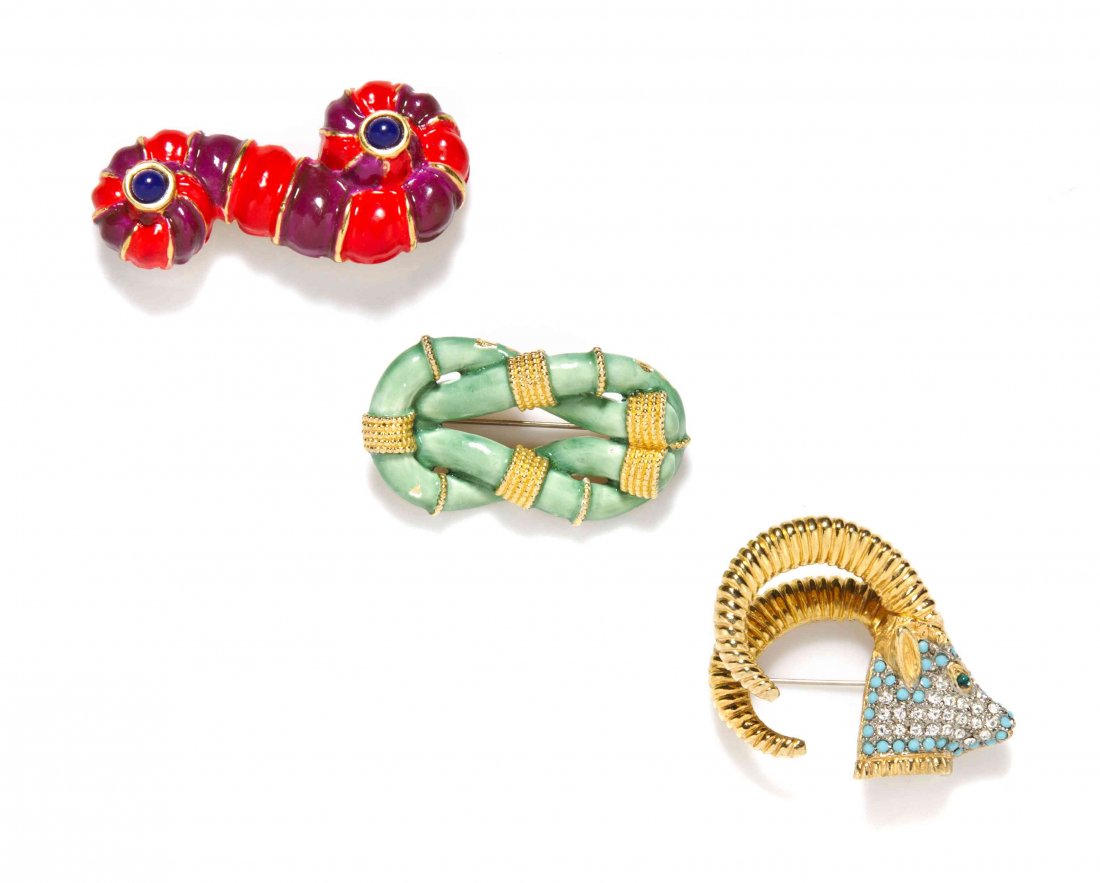 A Group of Three Kenneth Jay Lane Brooches,: A Group of Three Kenneth Jay Lane Brooches, comprised of a red and purple enamel and lapis cabochon abstract swirl, a green enamel knot and a turquoise and rhinestone ram's head. All stamped: K.J.L. P