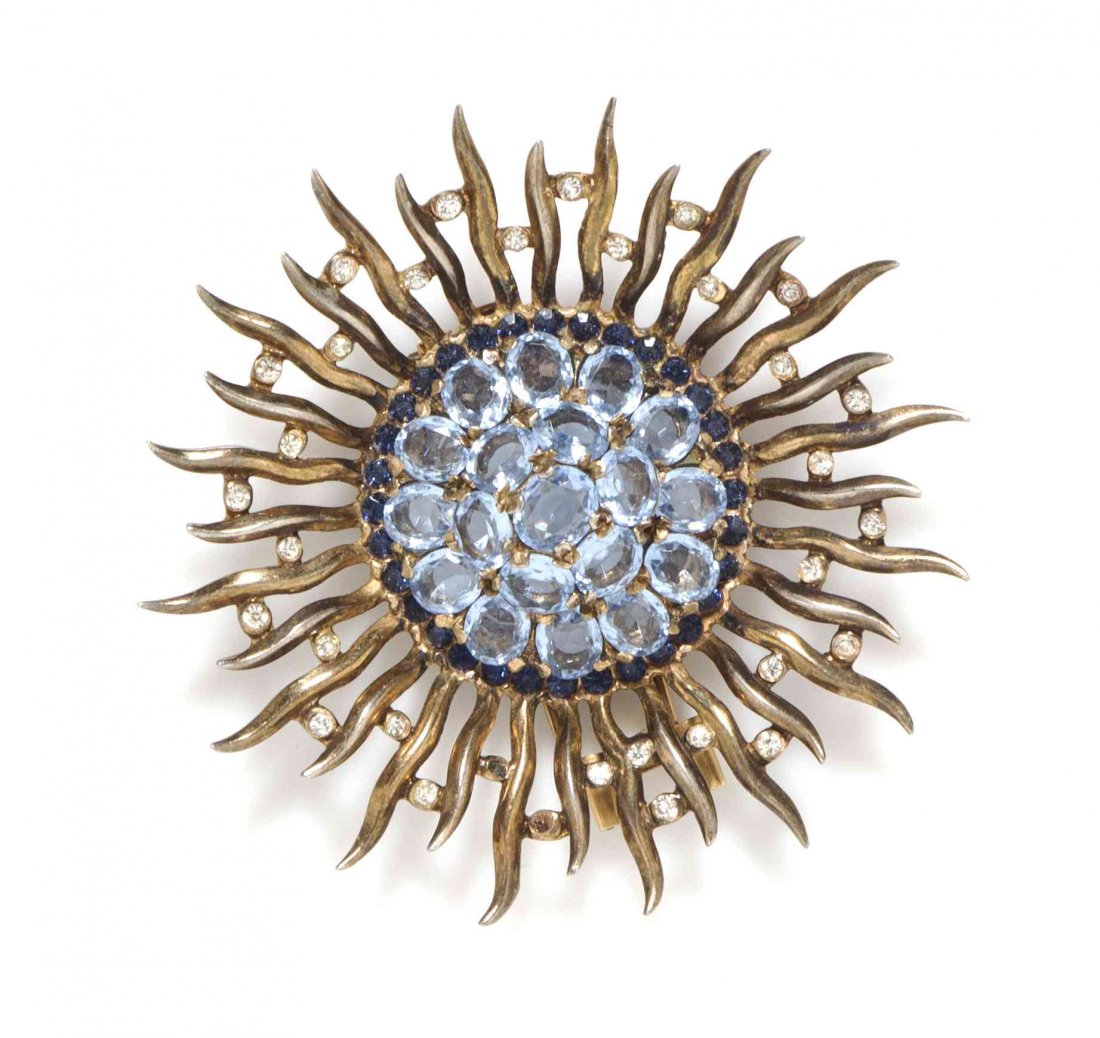 A Trifari Aquamarine Sunburst Sterling Fur Clip,: A Trifari Aquamarine Sunburst Sterling Fur Clip, dome center with wavy rays joined by small rhinestones. Stamped: Trifari (crown) / Sterling Des Pat. No 142666.