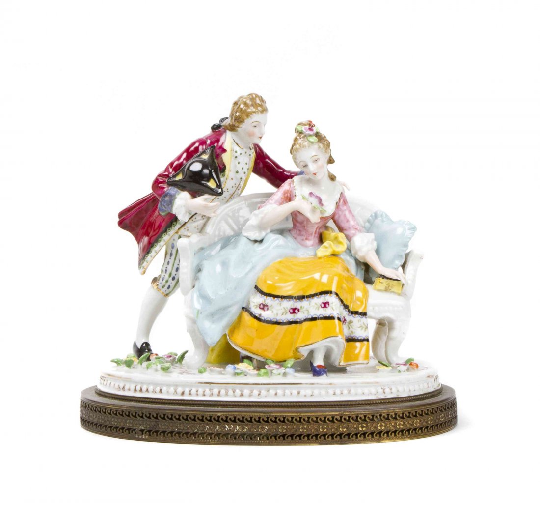 A German Porcelain Figural Group, Height 9 inches.: A German Porcelain Figural Group, depicting a woman seated on a couch and a man holding his hat. Height 9 inches. Property from the Estate of Gyula Serfozo, Boca Raton, Florida.