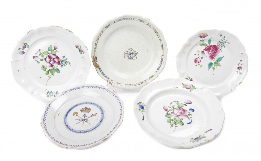 A Collection of Five Continental Faience Plates,: A Collection of Five Continental Faience Plates, comprising three examples with painted foliate decoration, one example having a central painted flower basket and geometric pattern boarder, the last e
