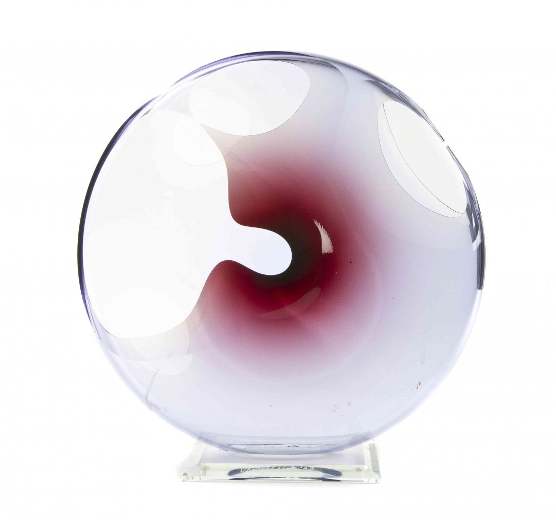 A Peter VanderLaan Glass Sculpture, Diameter 12 inches.: A Peter VanderLaan Glass Sculpture, round, with light smoke colored glass accents at center with shades of burgundy, with openwork freeform designs, on the rectangular glass base with etched signature
