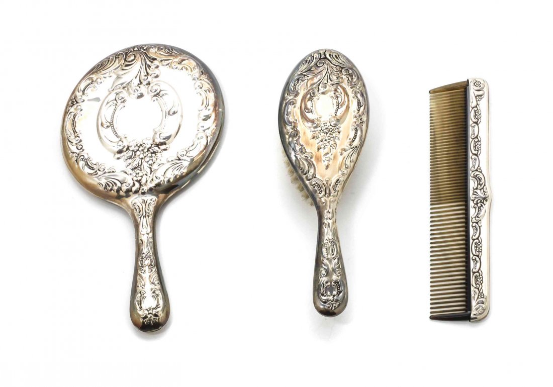 An American Silver Dresser Set, Wallace Silversmiths,: An American Silver Dresser Set, Wallace Silversmiths, Wallingford, CT, Second Half 20th Century, comprising a hand mirror, hair brush and comb, embossed with beaded scrolls, flowers and grapes, with o