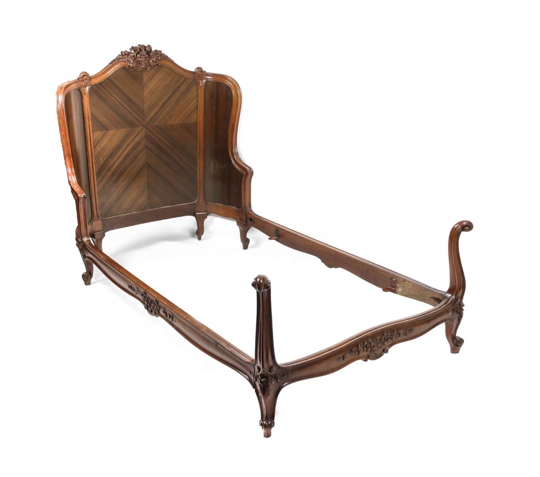A Pair of Louis XV Style Rosewood Beds, Height 50 x wid: A Pair of Louis XV Style Rosewood Beds, having floral bouquet carved crest rail, foot and side rails, raised on scroll form feet. Height 50 x width 43 x depth 78 inches. Property from the Estate of Be