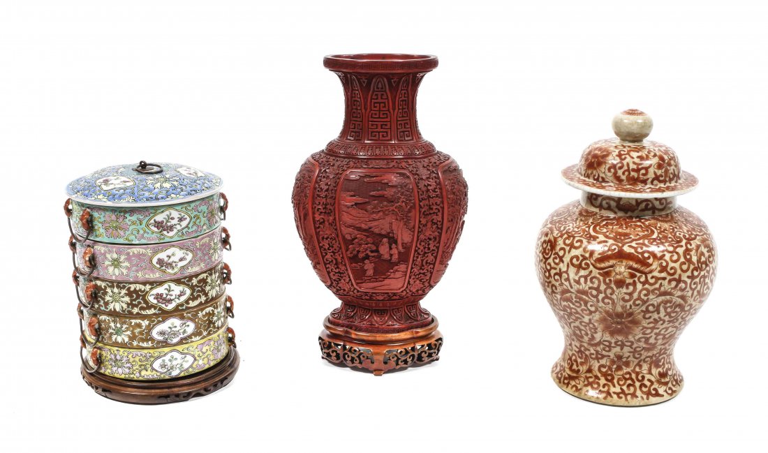 Two Chinese Porcelain Vessels, Height of tallest: Two Chinese Porcelain Vessels, comprising a covered ginger jar having iron red lotus and bat decoration and a set of stacking cylindrical food containers having polychrome decoration, raised on a wood