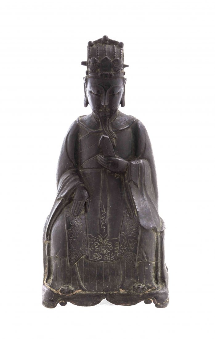 A Chinese Bronze Figure of an Official, Height 11 3/4: A Chinese Bronze Figure of an Official, Ming Dynasty, the figure depicted seated in a peaked headdress centered with Wang, having a long beard and downcast gaze, holding a tablet in one hand, the othe