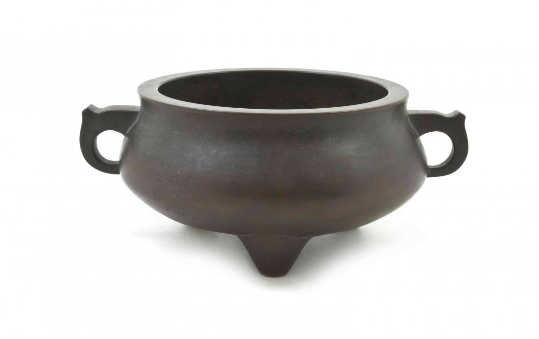 A Chinese Bronze Tripod Censer, Width over handles 7: A Chinese Bronze Tripod Censer, 19th century, having a squat body with two ring handles, with a dark olive brown patina, bearing six-character Xuande mark to the underside. Width over handles 7 1/2 in