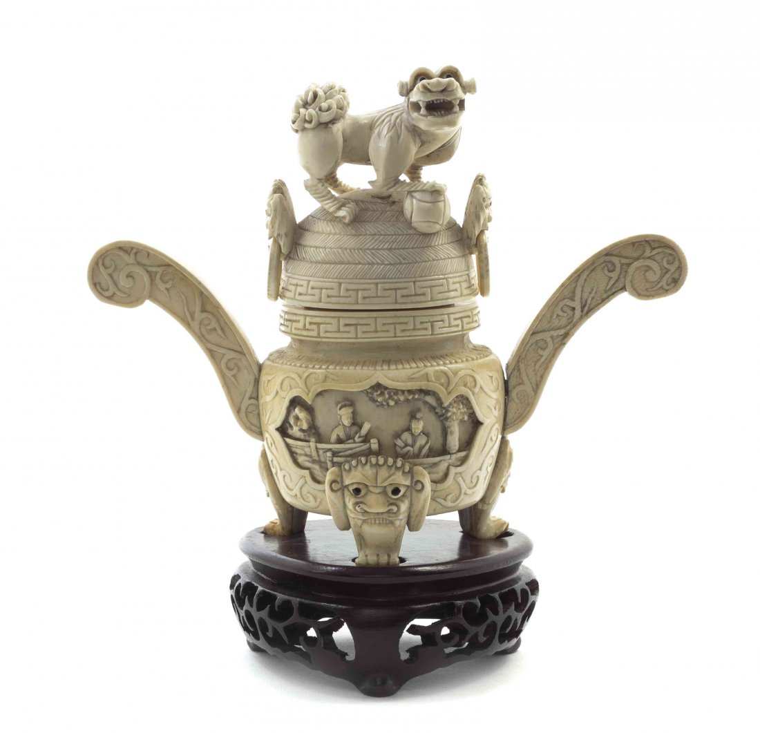A Chinese Carved Ivory Tripod Censer, Height 5 7/8: A Chinese Carved Ivory Tripod Censer, the domed cover surmounted with a temple lion, the body having relief carved figural scenes in shaped, recessed reserves and flanked by scrolled flange handles, r