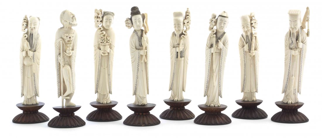 A Set of Eight Chinese Carved Ivory Daoist Immortals,: A Set of Eight Chinese Carved Ivory Daoist Immortals, each depicted standing in draped robes having similar scrolled band decoration, bearing his or her traditional attribute, raised on a hardwood bas