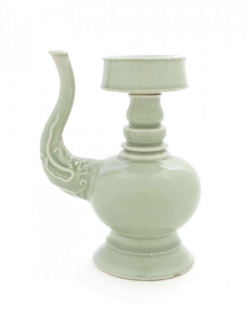 A Chinese Celadon Glaze Porcelain Ewer, Height 8: A Chinese Celadon Glaze Porcelain Ewer, having an elephant-form spout and a thick dished mouth above a waisted standard and bulbous body, raised on a pedestal foot. Height 8 inches.